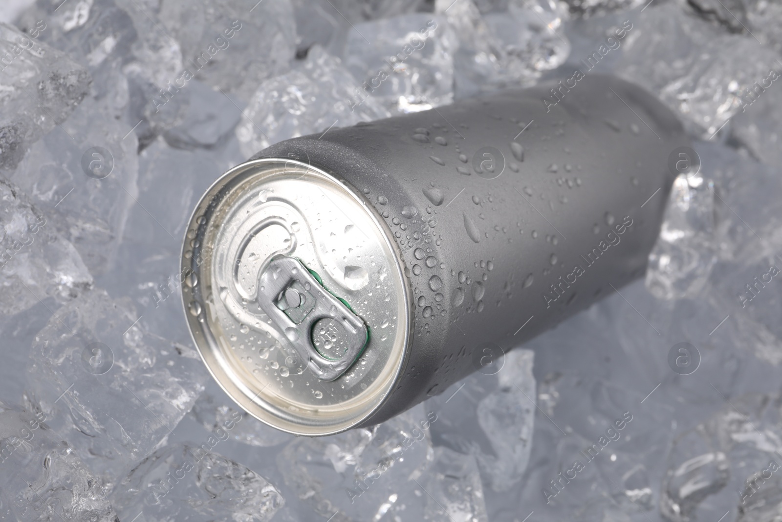 Refreshing drink in can on ice cubes, closeup Photo of Refreshing drink in can on ice cubes, closeup