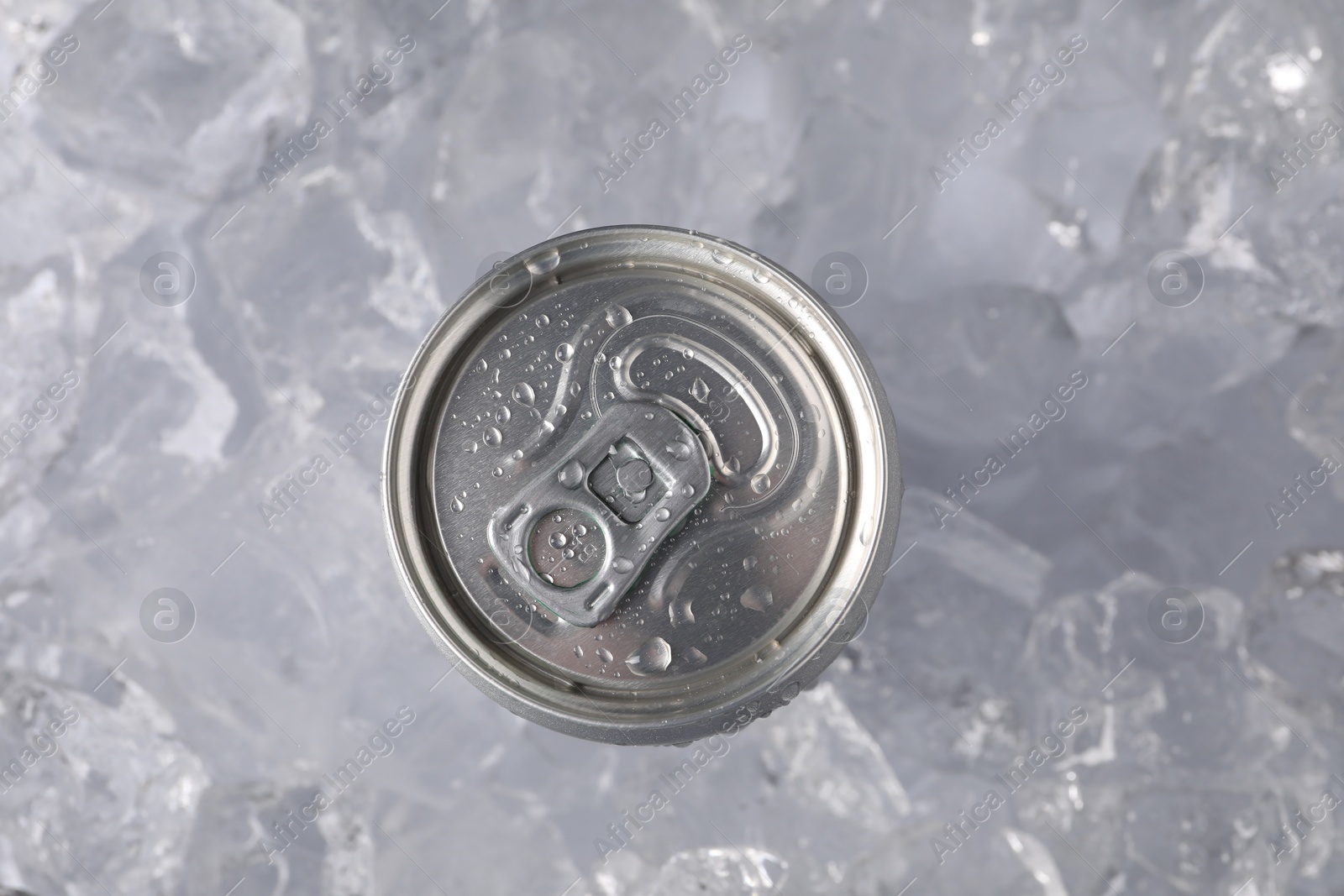 Refreshing drink in can on ice cubes, top view Photo of Refreshing drink in can on ice cubes, top view