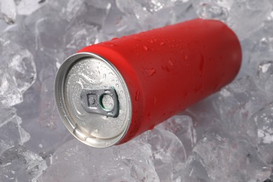 Photo of Refreshing drink in can on ice cubes, closeup