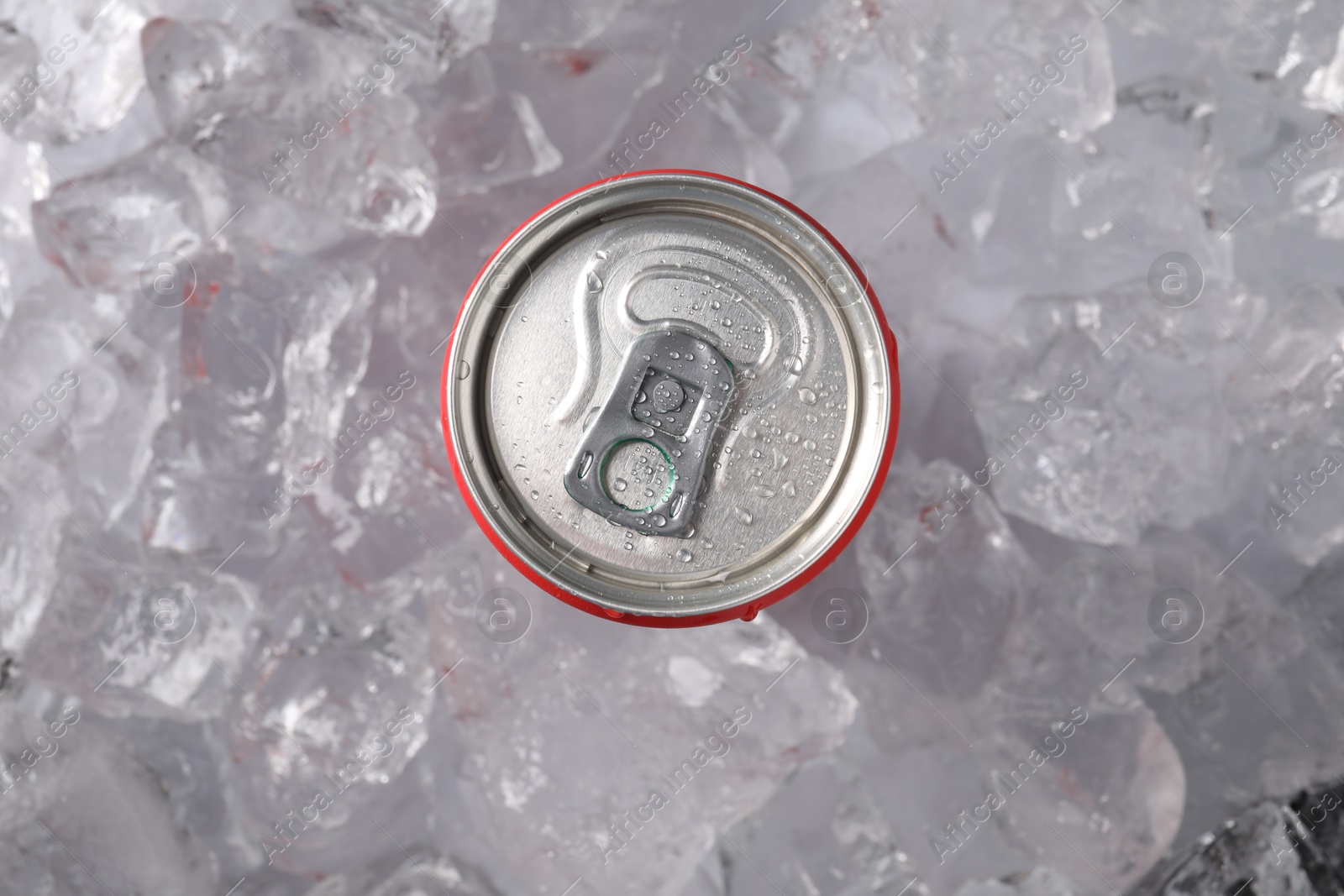 Refreshing drink in can on ice cubes, top view Photo of Refreshing drink in can on ice cubes, top view