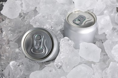 Photo of Cans of refreshing drink in ice cubes, above view