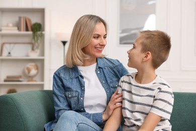 Mother and son on sofa at home