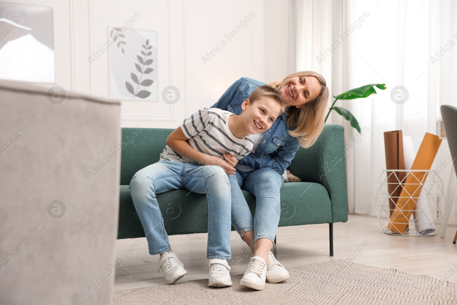 Photo of Mother and son having fun at home