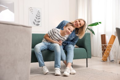 Photo of Mother and son having fun at home