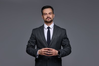 Photo of Confident man in classic suit on grey background