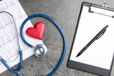 Photo of Cardiology. Cardiogram, stethoscope, red decorative heart, clipboard and pen on gray textured background, flat lay