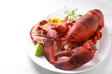 Photo of Delicious boiled lobster served on white table, closeup