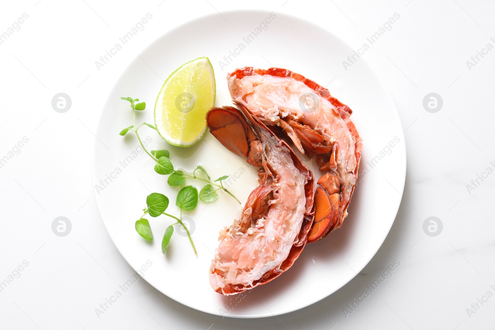 Photo of Delicious boiled lobster served on white table, top view