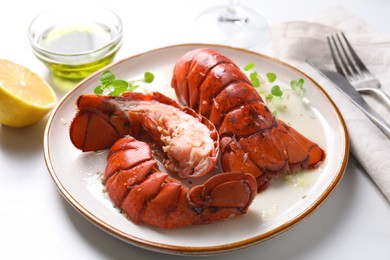 Delicious tails of boiled lobsters served on white table, closeup