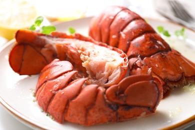 Delicious tails of boiled lobsters served on white table, closeup