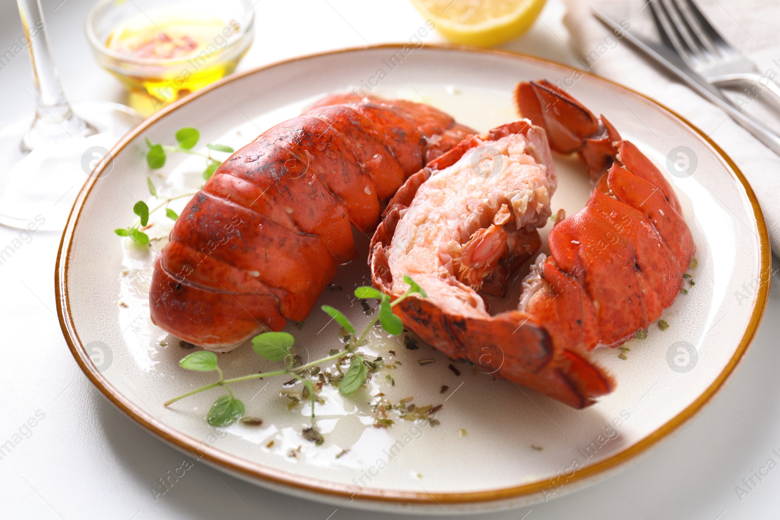 Photo of Delicious tails of boiled lobsters served on white table, closeup