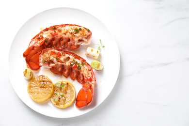 Delicious lobster tails with lemon, microgreens and green onion on white marble table, top view. Space for text