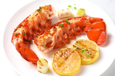 Photo of Delicious lobster tails with lemon, microgreens and green onion on white table, closeup