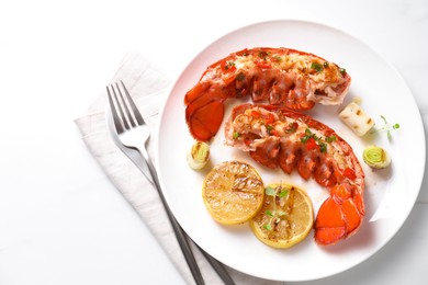 Photo of Delicious lobster tails with lemon, microgreens and green onion on white table, top view. Space for text