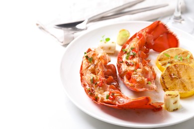 Delicious lobster tails with lemon, microgreens and green onion on white table, closeup. Space for text