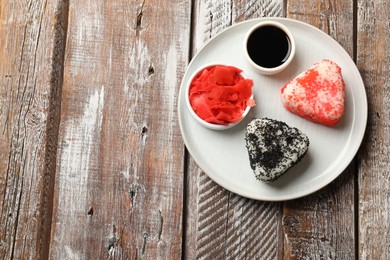 Photo of Tasty tobiko onigiri (Japanese rice balls) served on wooden table, top view