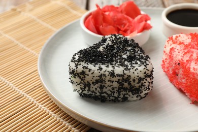 Photo of Tasty tobiko onigiri (Japanese rice balls) served on table, closeup