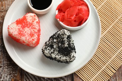 Photo of Tasty tobiko onigiri (Japanese rice balls) served on wooden table, top view