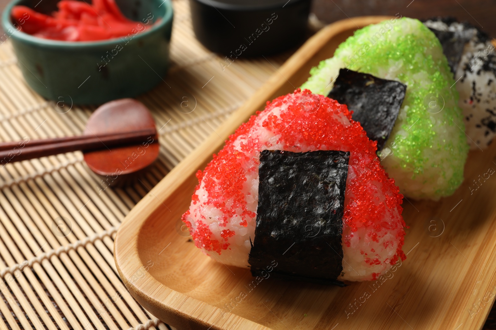 Tasty tobiko onigiri (Japanese rice balls) served on table, closeup Photo of Tasty tobiko onigiri (Japanese rice balls) served on table, closeup