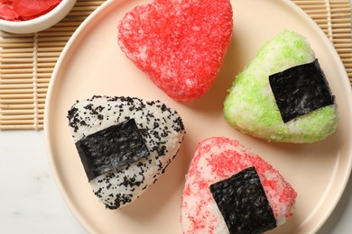 Photo of Tasty tobiko onigiri (Japanese rice balls) served on white table, top view