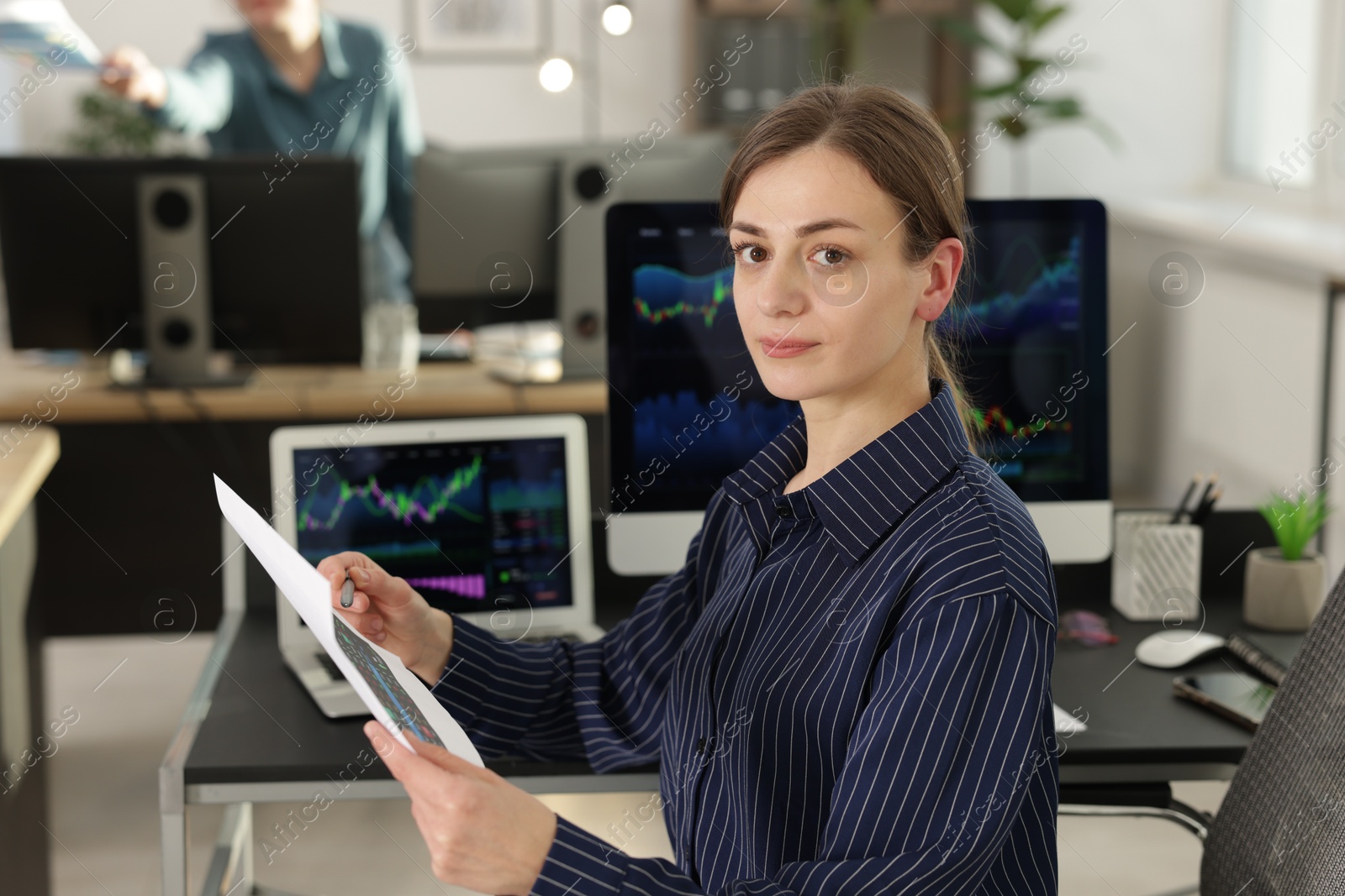 Photo of Stock exchange. Woman working at desk in office