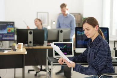 Photo of Stock exchange. Woman working at desk in office