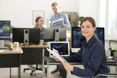 Photo of Stock exchange. Woman working at desk in office