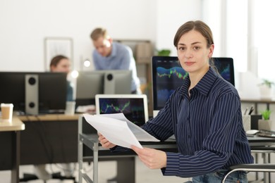 Photo of Stock exchange. Woman working at desk in office