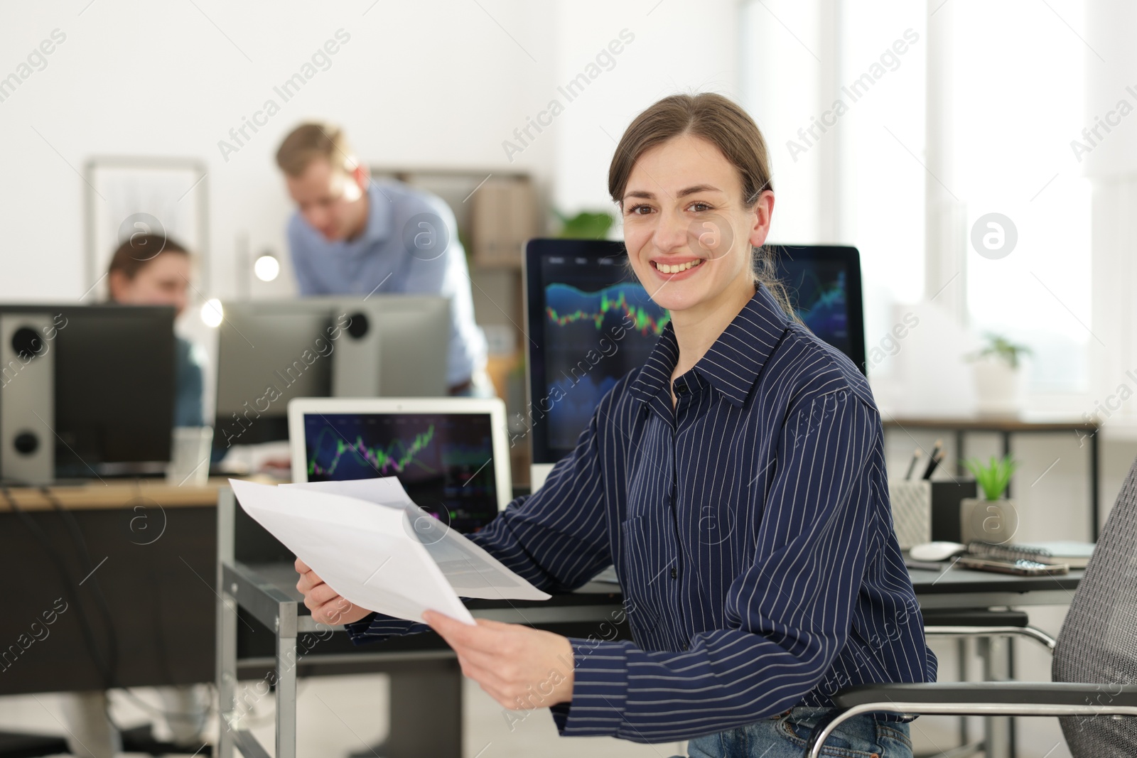 Photo of Stock exchange. Woman working at desk in office