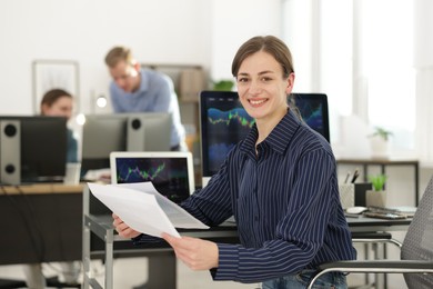 Photo of Stock exchange. Woman working at desk in office