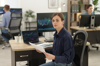 Photo of Stock exchange. Woman working at desk in office