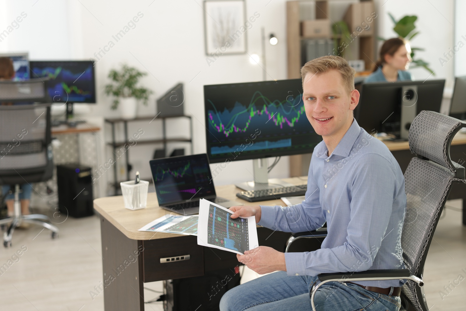 Photo of Stock exchange. Man working at desk in office