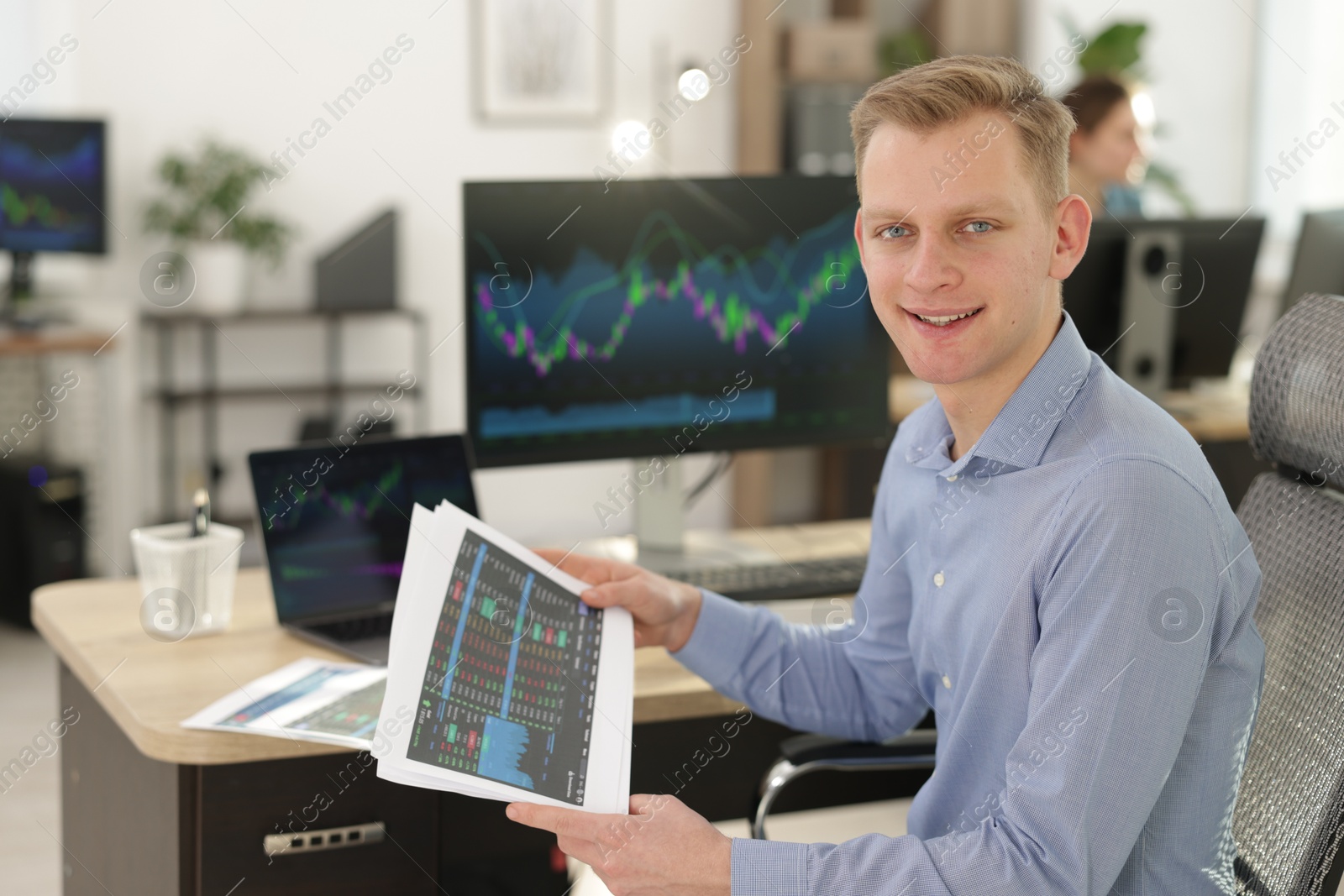 Photo of Stock exchange. Man working at desk in office