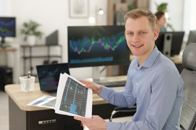 Photo of Stock exchange. Man working at desk in office