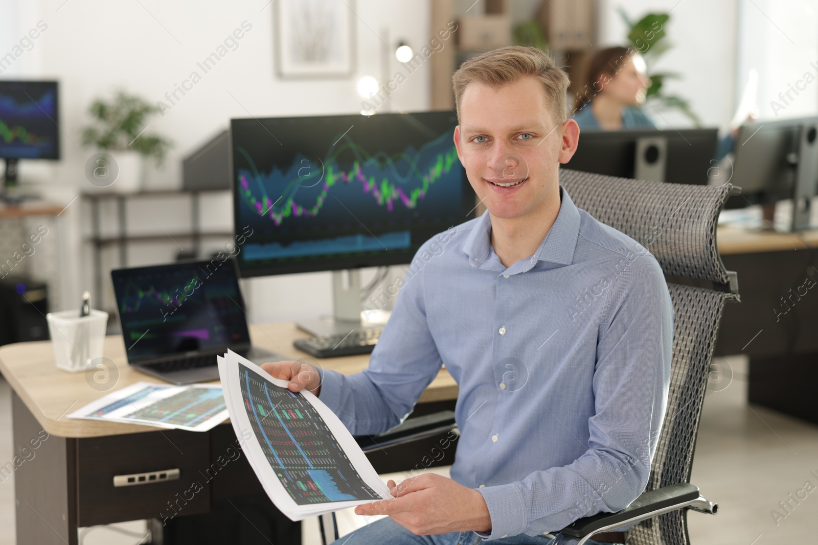 Photo of Stock exchange. Man working at desk in office