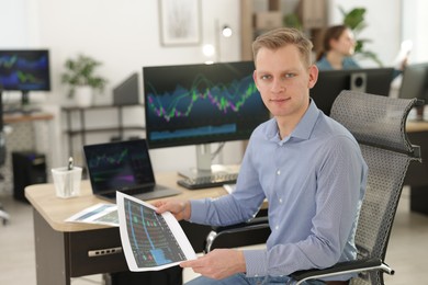 Photo of Stock exchange. Man working at desk in office