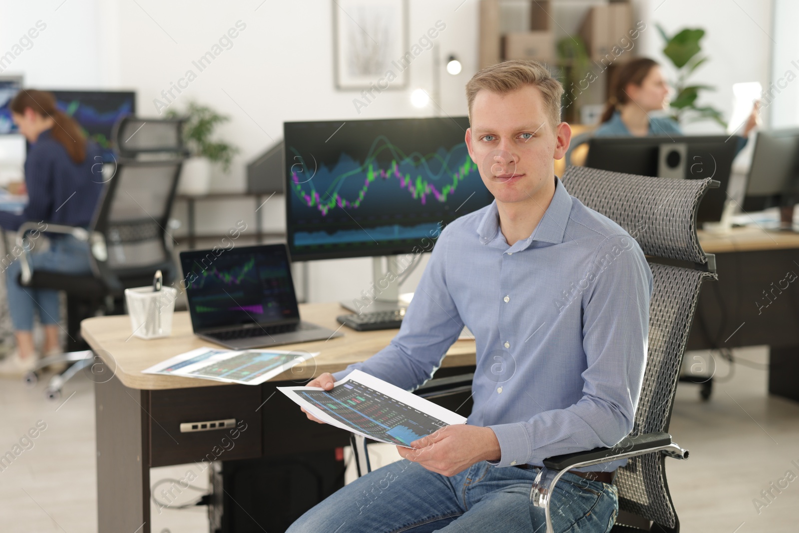 Photo of Stock exchange. Man working at desk in office