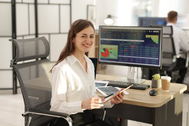 Stock exchange. Woman working at desk in office