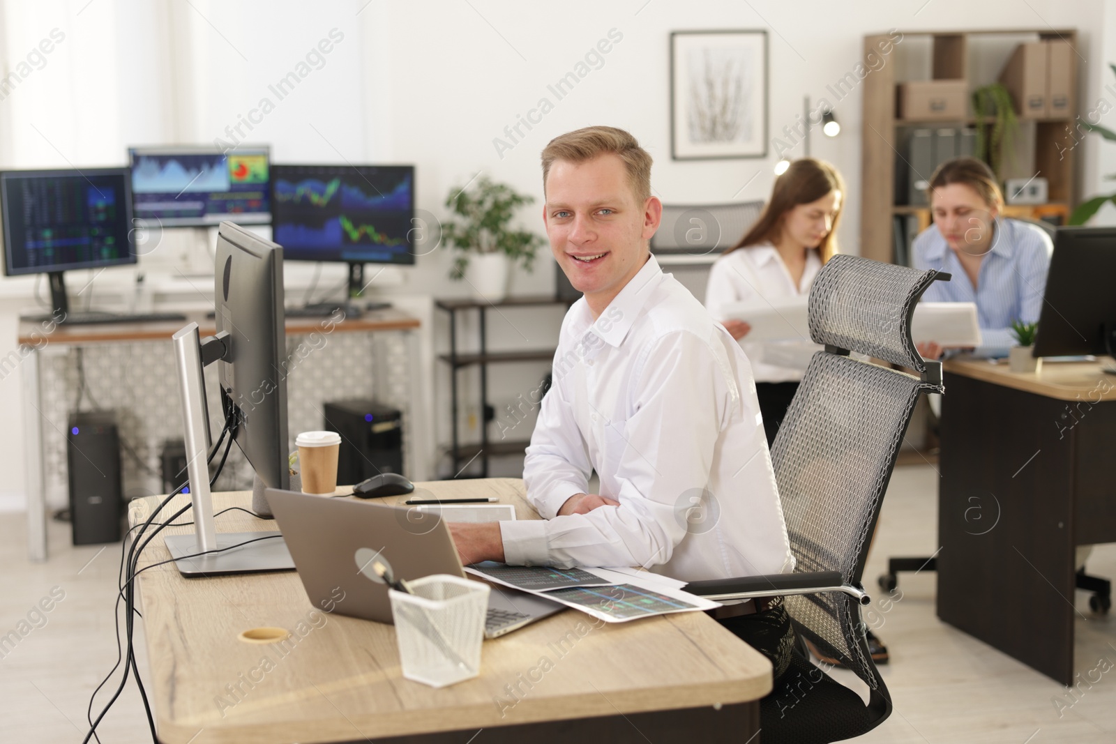 Photo of Stock exchange. Man working at desk in office