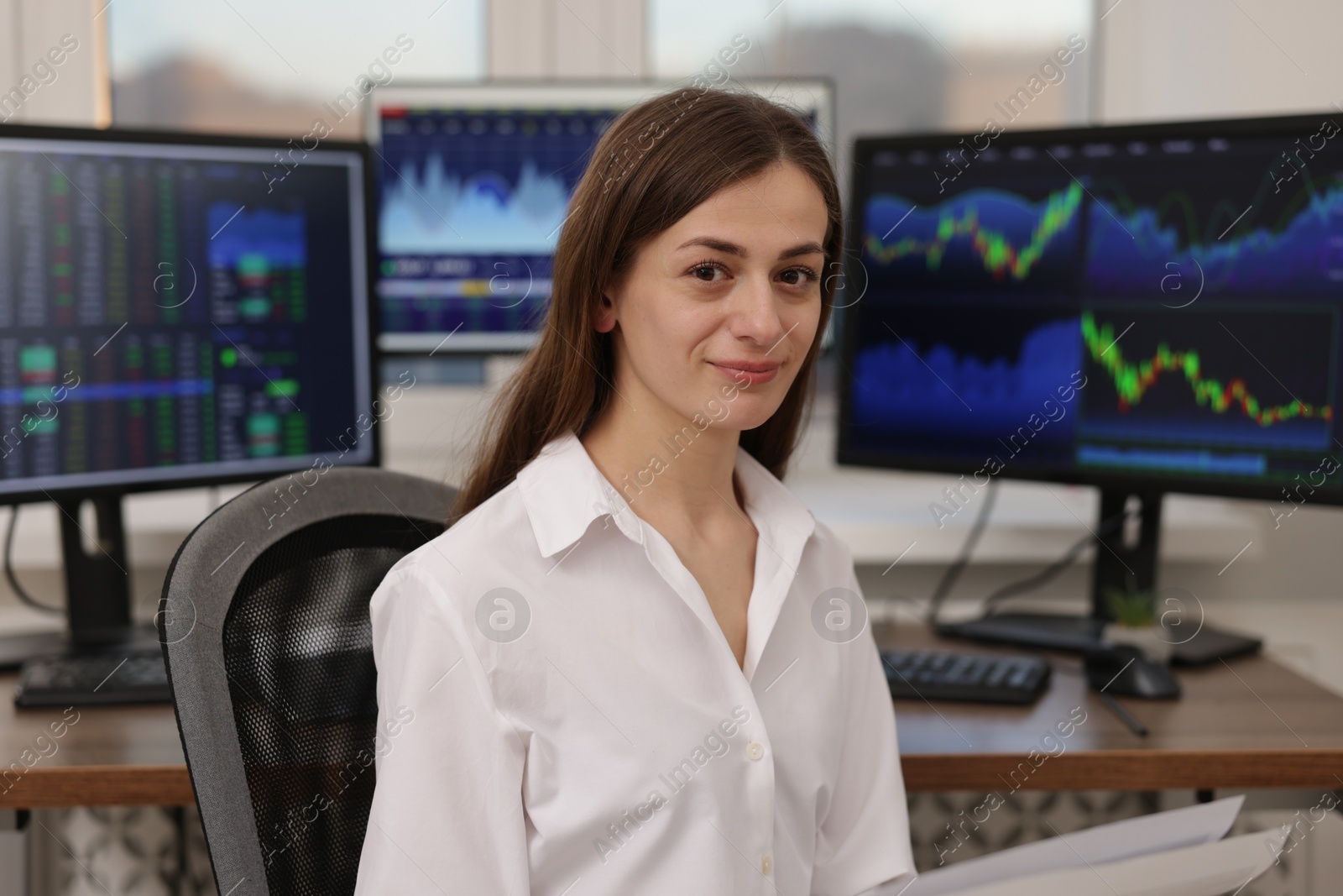 Photo of Stock exchange. Woman working at desk in office