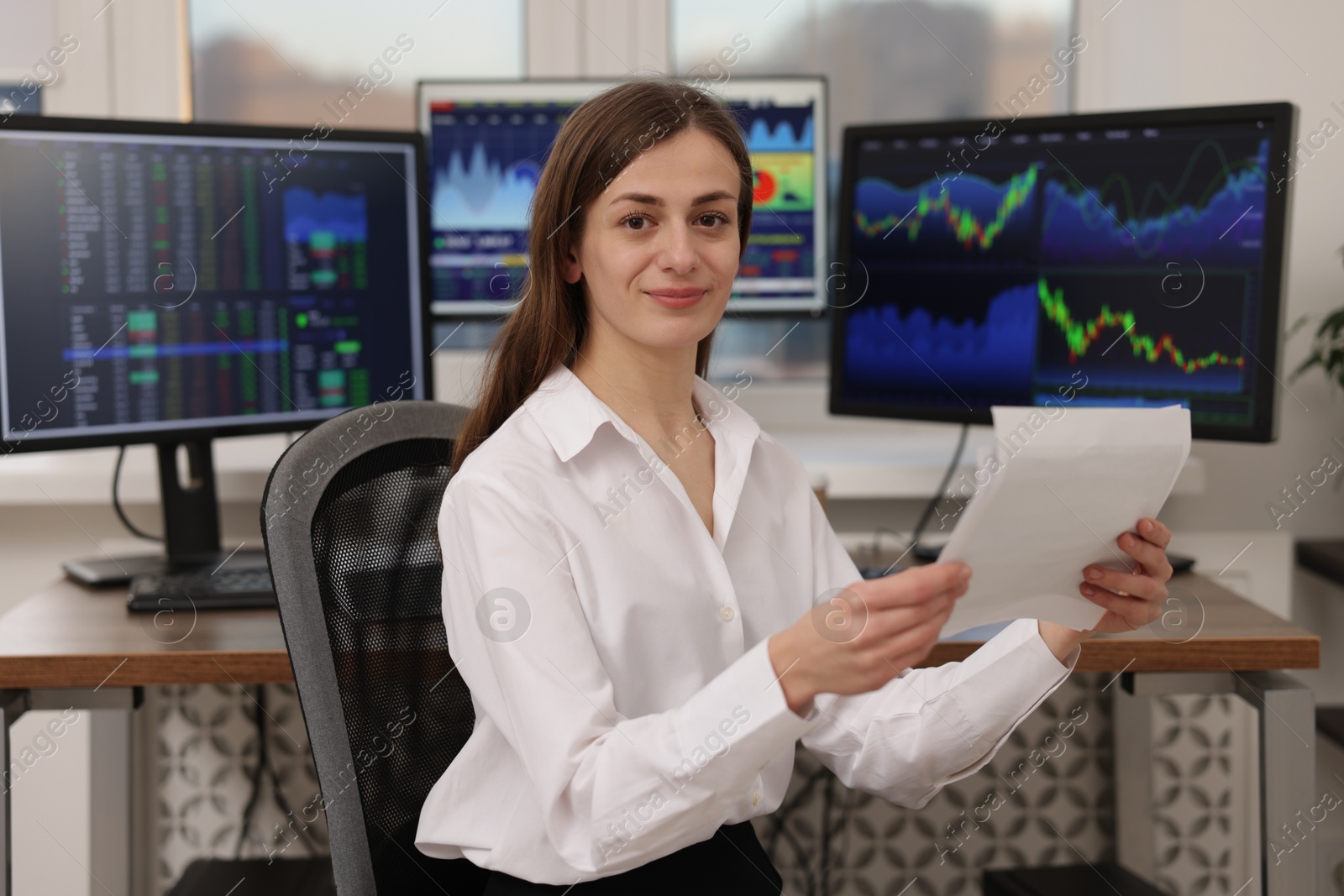 Photo of Stock exchange. Woman working at desk in office