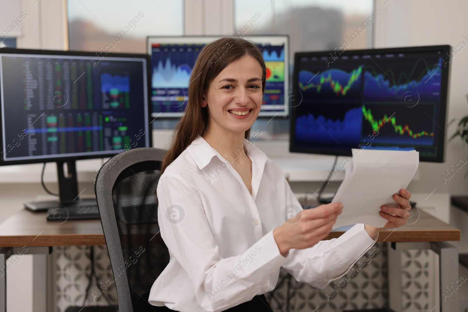 Photo of Stock exchange. Woman working at desk in office