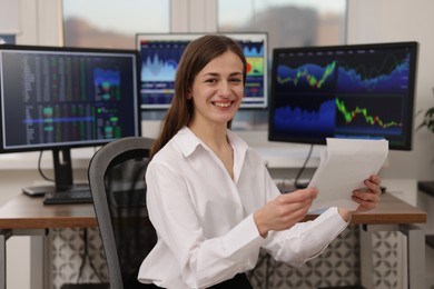 Photo of Stock exchange. Woman working at desk in office