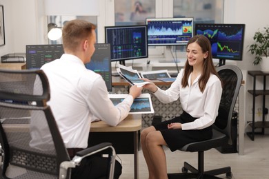 Photo of Stock exchange. Colleagues working together in office