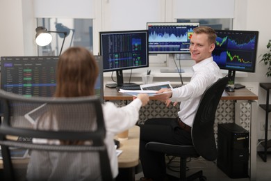 Photo of Stock exchange. Colleagues working together in office