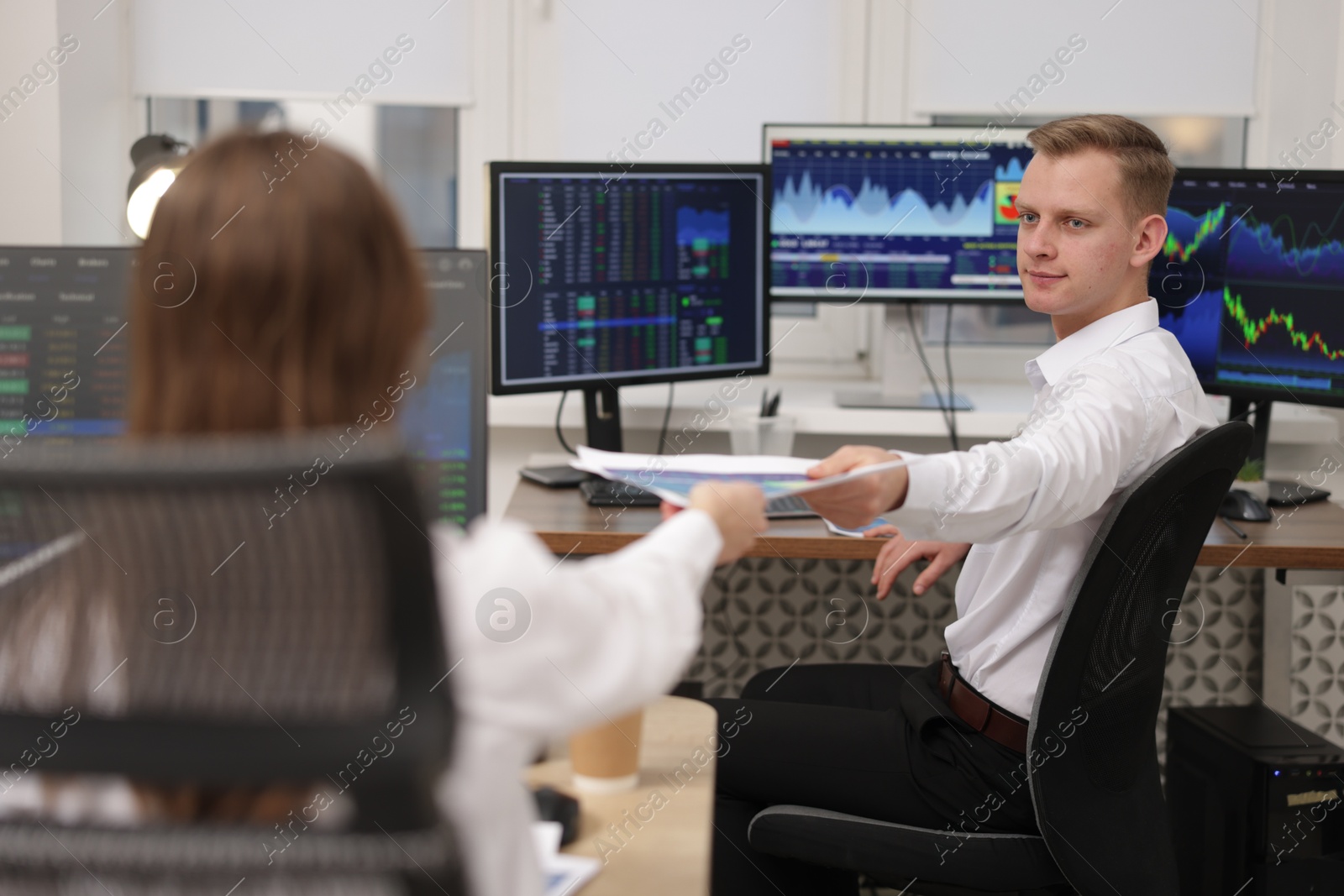 Photo of Stock exchange. Colleagues working together in office