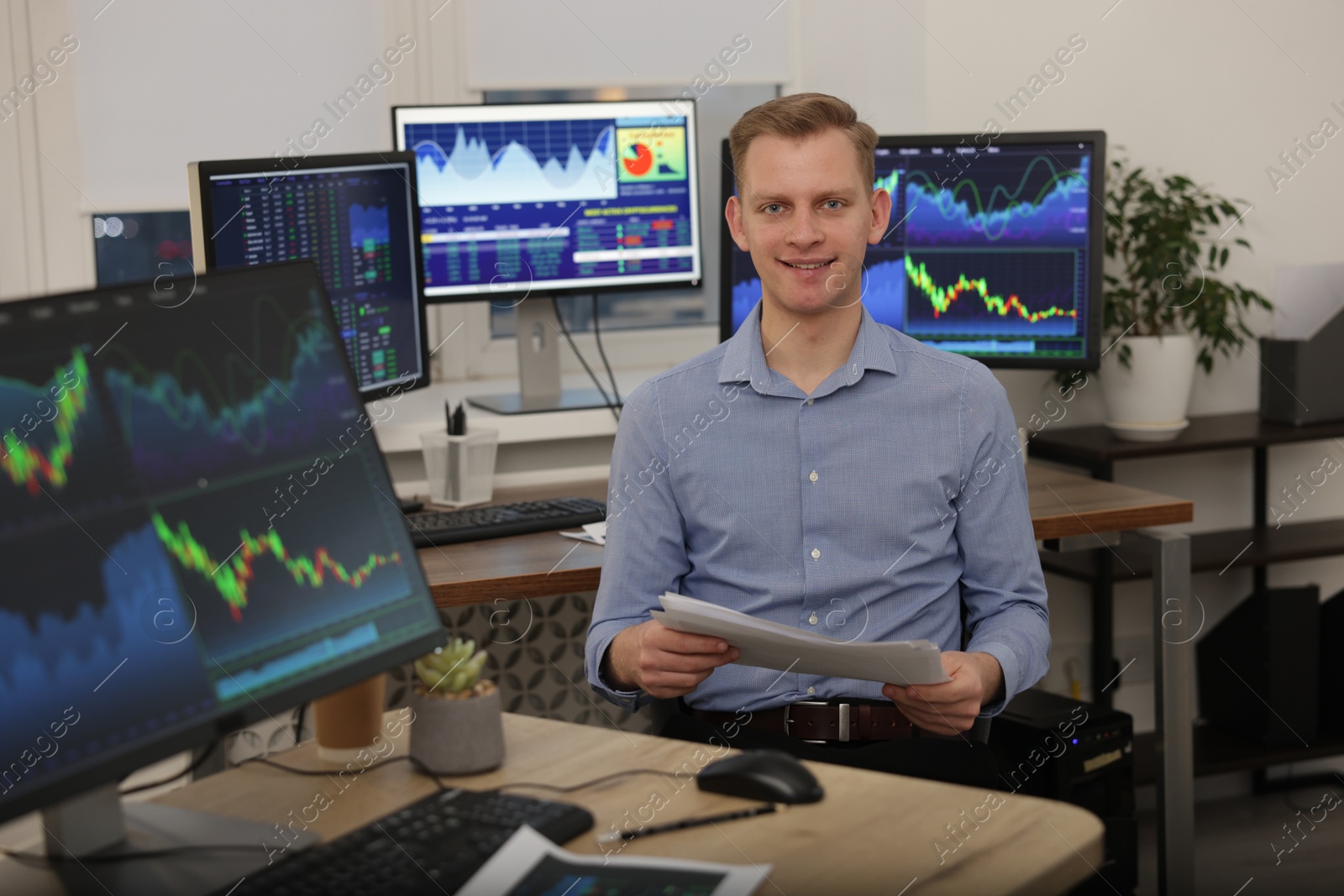 Photo of Stock exchange. Man working at desk in office