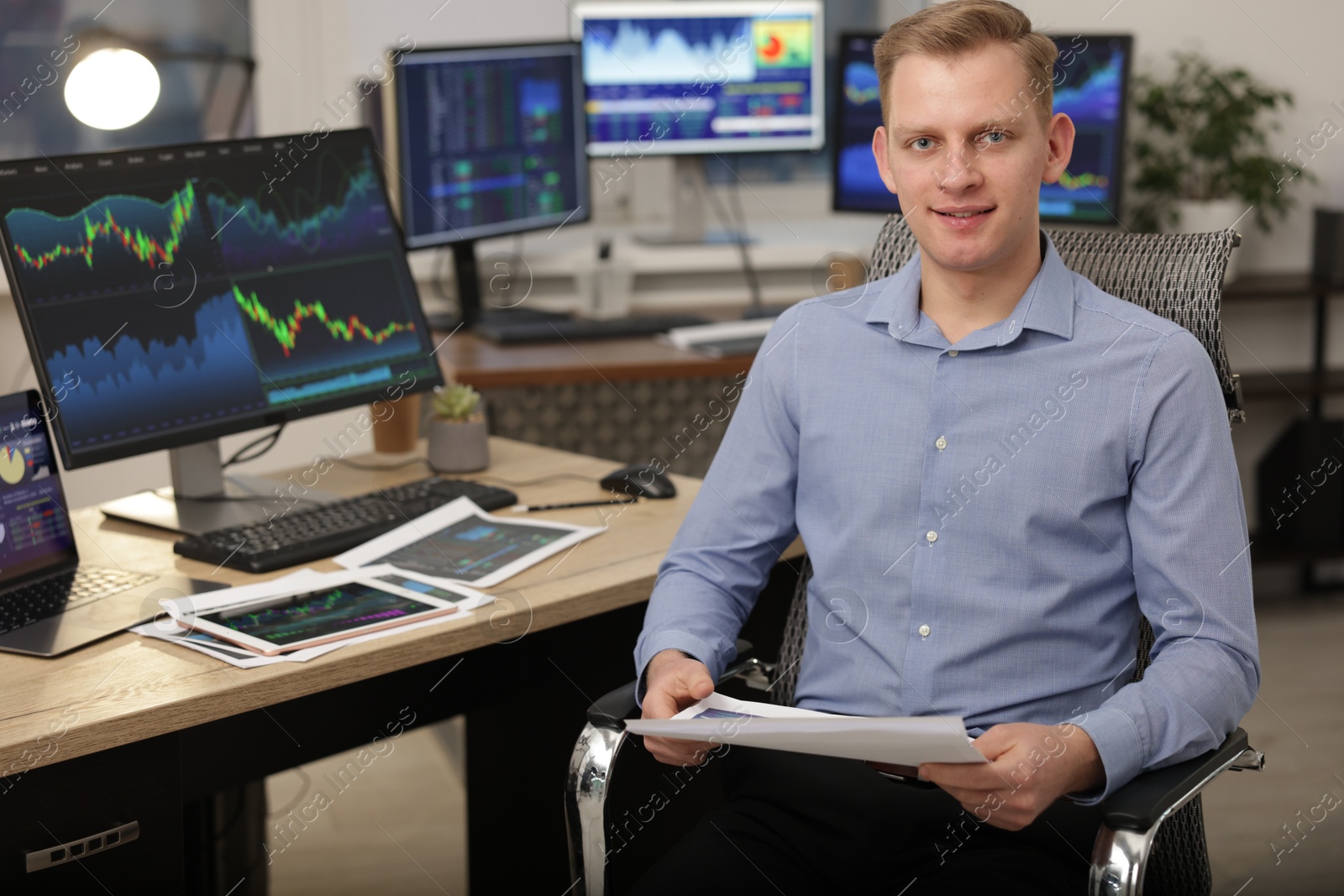 Photo of Stock exchange. Man working at desk in office