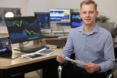 Photo of Stock exchange. Man working at desk in office