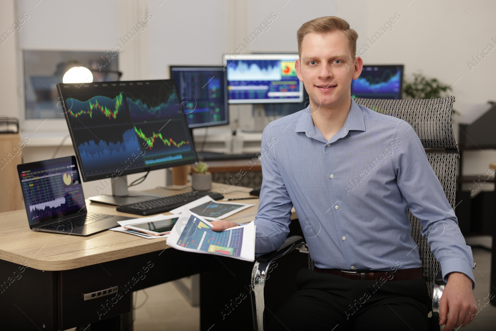 Photo of Stock exchange. Man working at desk in office